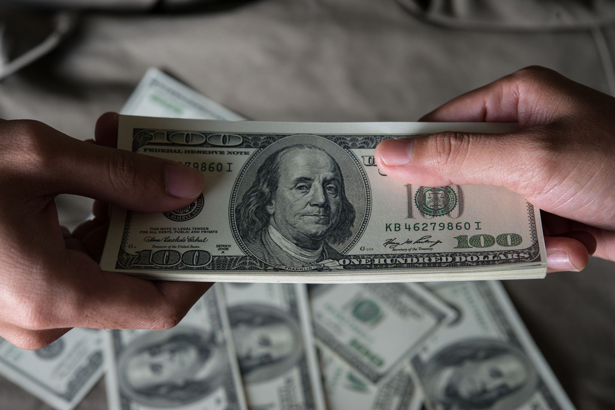 a person holding a stack of money